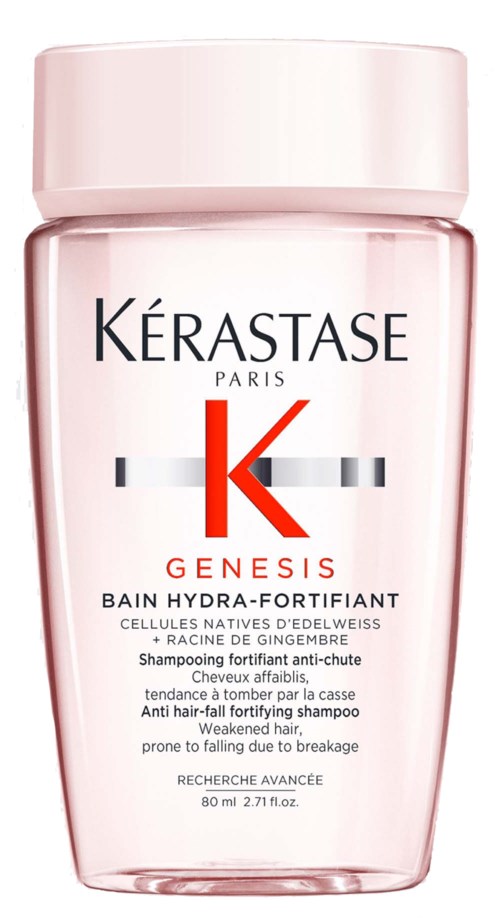 Pinkki Kérastase Genesis -shampoopullo, valkoinen korkki ja etiketti.