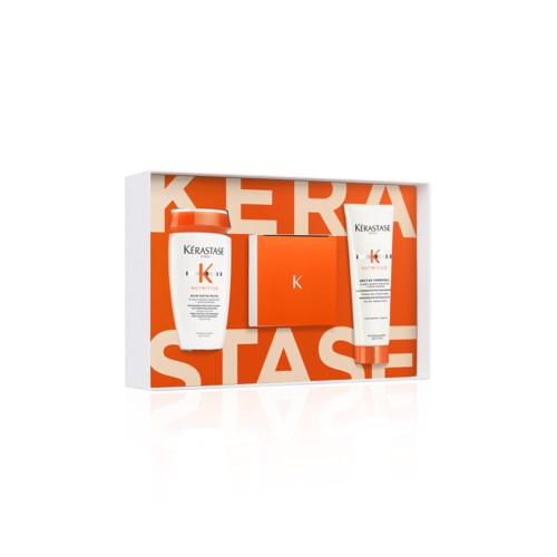 A skincare set with shampoo, conditioner, and a small orange box, all branded Kérastase.