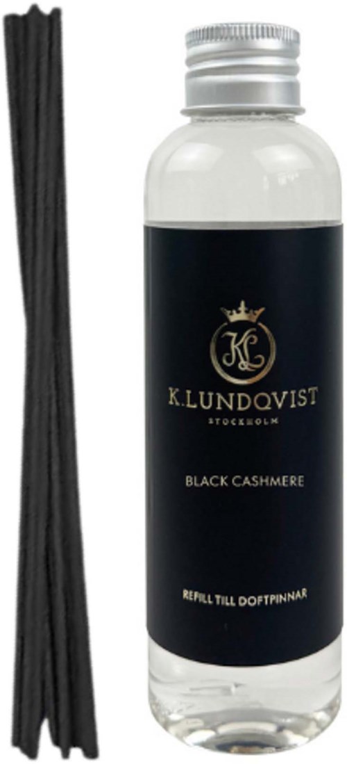 En flaske med sort cashmere duft med sorte røgelsesstænger ved siden af.