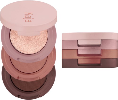 Et sæt af fire runde makeup-beholdere stablet, i nuancer af pink, brun og beige, med en glitter.