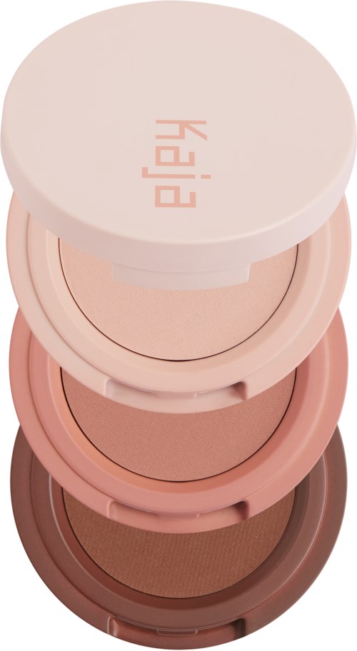 Stablede runde sminke containere i ulike nyanser av rosa og brunt. Den øverste beholderen har ordet "PEACH" på seg.