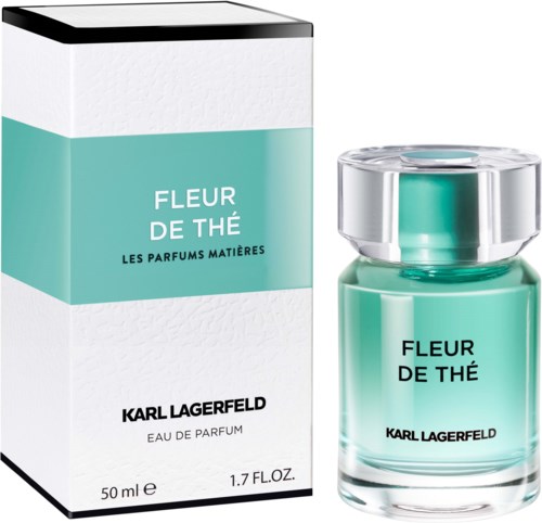 A perfume bottle and box labeled 'Fleur de Thé' by Karl Lagerfeld, green and white colors. A floral scent product.