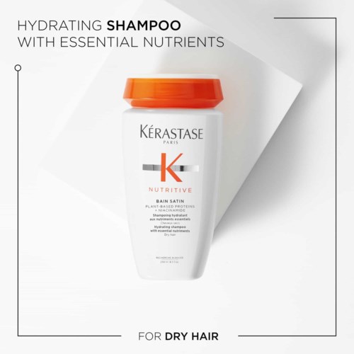 A white shampoo bottle with an orange lid, labeled for dry hair, containing nutrients for hydration.