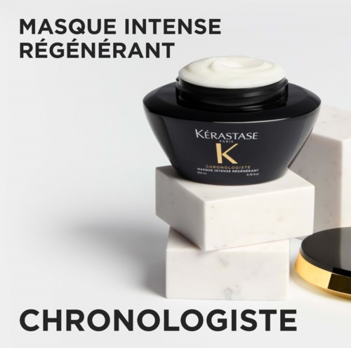 En svart burk med vit kräm på, på vita block, med text som marknadsför en närande hårmask.