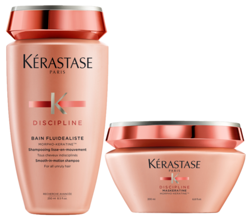 Two peach-colored hair care products from Kérastase Discipline line, one bottle, one jar, with silver lids.