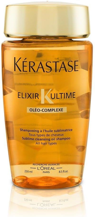 En liten oransje flaske med gullhette merket 'Kérastase Elixir K Ultime' for alle hårtyper sjampo.
