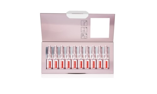 A box contains several small bottles labeled with red and white, arranged in a row. The box has an open lid and instructions inside.