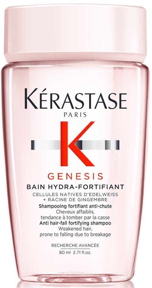 En rosa schampoflaska med svart, rött och grått text, kallad Kérastase Genesis, för svagt hår.