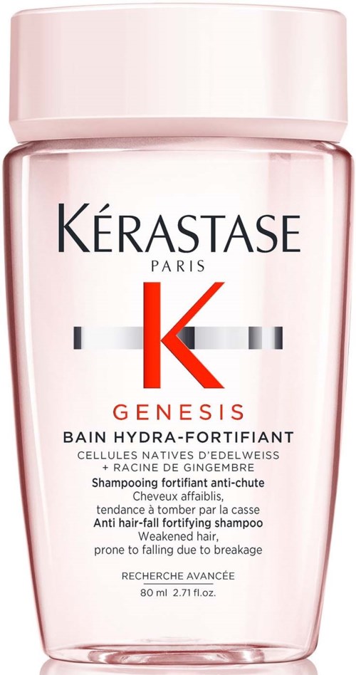 En rosa flaska av Kérastase Genesis schampo för försvagat hår, med svart och röd text och logotyp.