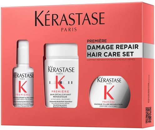 Haarverzorgingsset met shampoo, conditioner en masker van Kérastase, in roze verpakking, voor beschadigd haar.