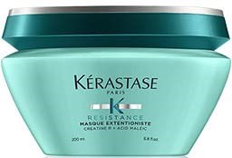 En ljusgrön burk märkt Kérastase Resistance Masque Extentioniste för hårvård, med ett mörkgrönt lock.