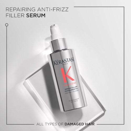 En hårserumflaska med pump, silver- och vit design, märkt för anti-frizz och skadat hårreparation.