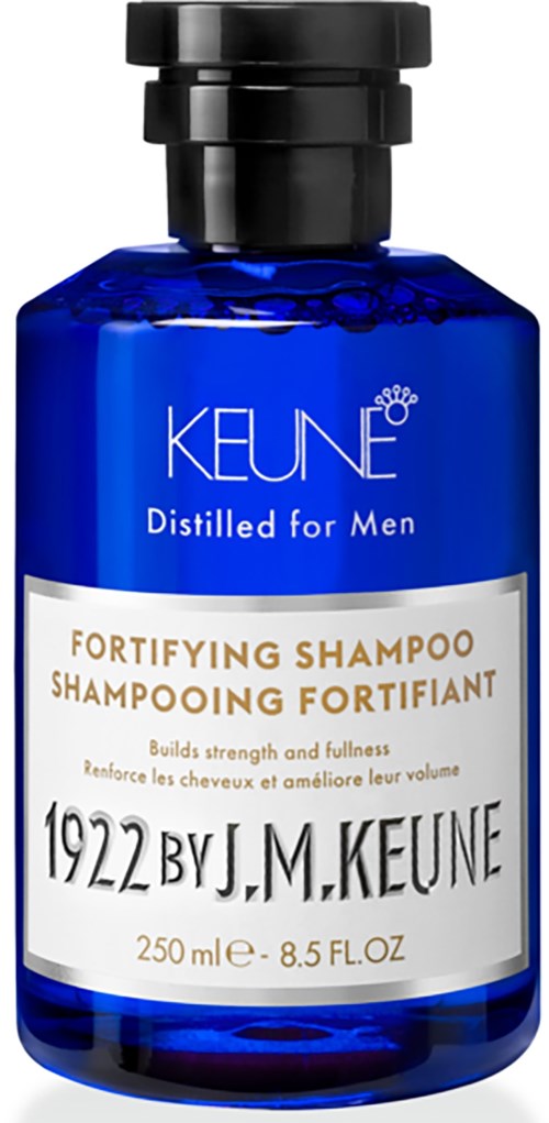 Eine blaue Flasche mit Keune stärkendes Shampoo für Männer, mit schwarzem Deckel und weißem und goldenem Etikett.