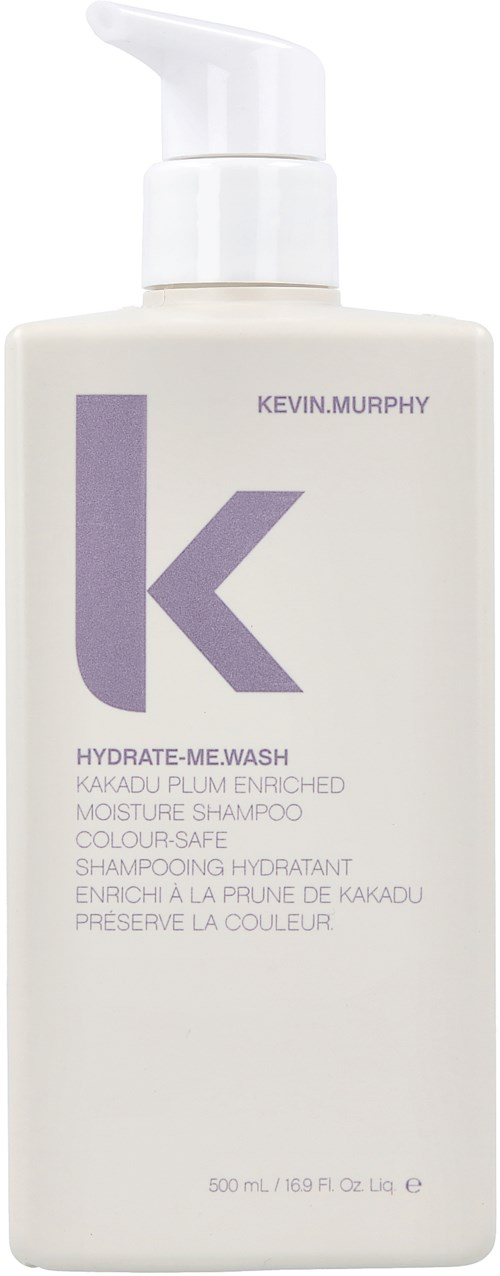 A white bottle with a pump contains Kevin Murphy hair shampoo, labeled as hydrate-me wash with purple text and logo.
