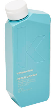 En blå flaske med hvid lås, mærket Kevin Murphy Repair-Me-Wash. Det ligner en shampoo-flaske.