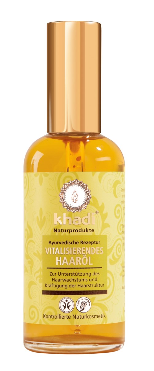 En gul flaska med guldkork, märkt 'Vitaliserande Hårolja' på tyska, med växtsymboler och naturliga produktuppgifter.