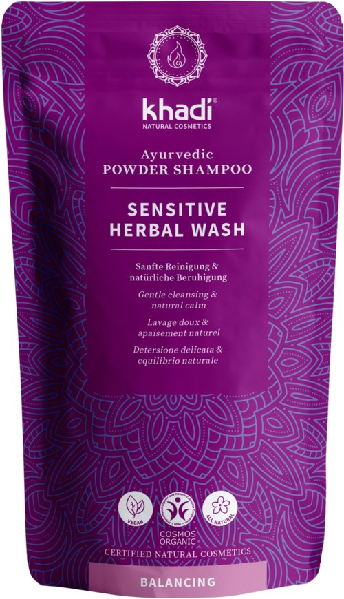 Purple bag with herbal shampoo for sensitive scalp, emphasizes gentle cleansing, natural calm, and balancing care.