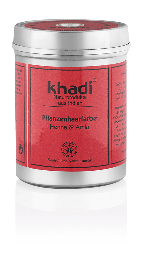 En rød beholder med sølvdeksel, merket 'Khadi' og nevner plantebasert hårfarge med henna og amla.