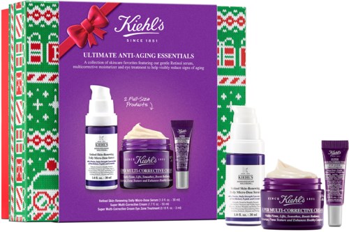 Förpackning med Kiehls hudvårdsprodukter, inklusive krämer och serum, dekorerad med festliga julmönster och ett band.