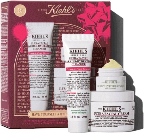 Kiehl's hudpleiesett med ansiktsrenser, øyekrem og krem med avokado i rosa og hvitt emballasje.