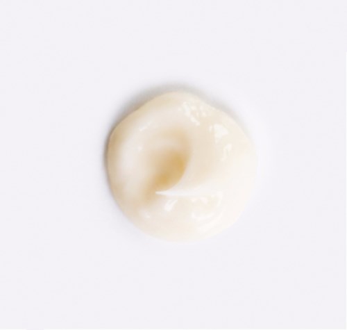 A swirl of white cream or lotion on a white background.