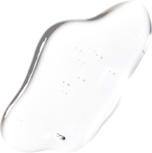 En tydlig, tjock vätskesplash med små bubblor, möjligtvis vatten eller gel, formad oregelbundet på en vit bakgrund.