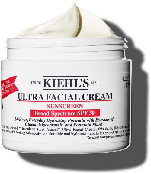 A white jar of Kiehl's Ultra Facial Cream with red and black text, open with cream inside.