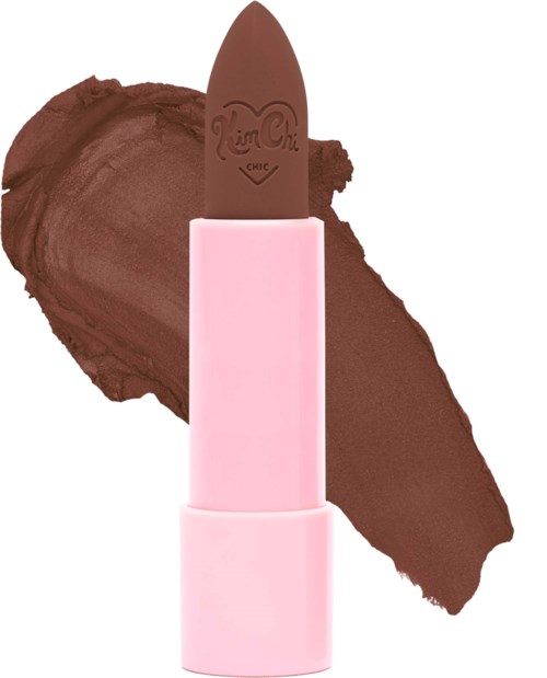 A pink lipstick with a brown lipstick inside, against a background of brown lipstick smear.