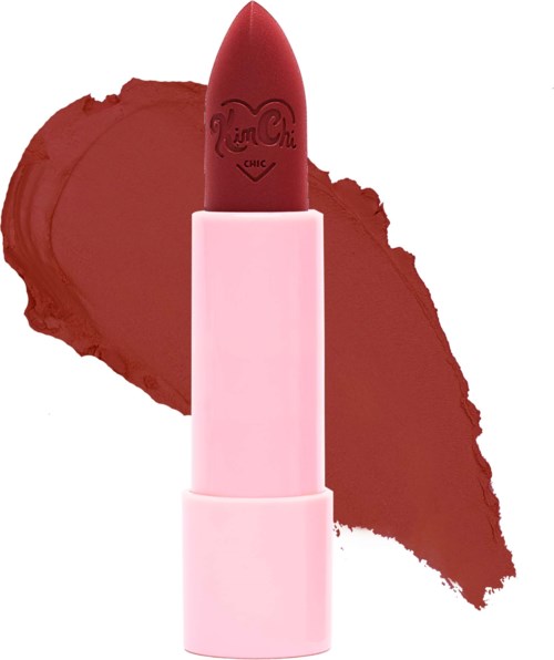 A pink lipstick with a red tip, standing upright with a red swatch in the background.