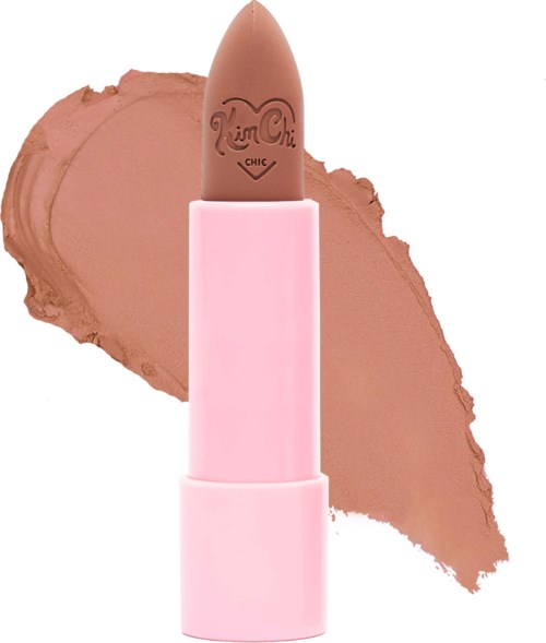 A brown lipstick in a pink case, with a smear of brown lipstick behind it.