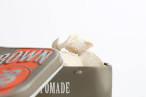 A black container with white ice cream and a partially visible colorful lid with text.