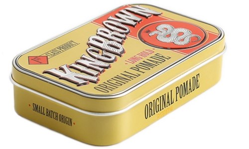 A yellow tin box with red and white text for hair pomade, labeled as original and small batch.