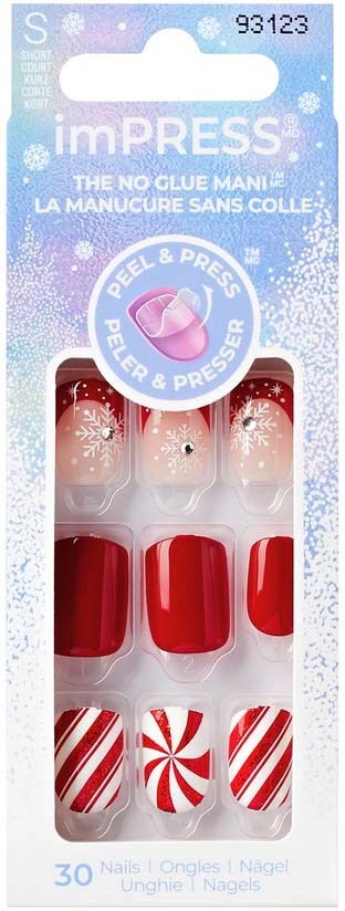 Manicure set with red and white Christmas-themed nail designs in packaging.