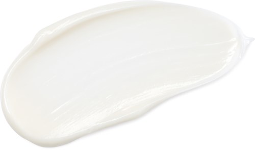 White cream or lotion spread on a black background with a curved shape.