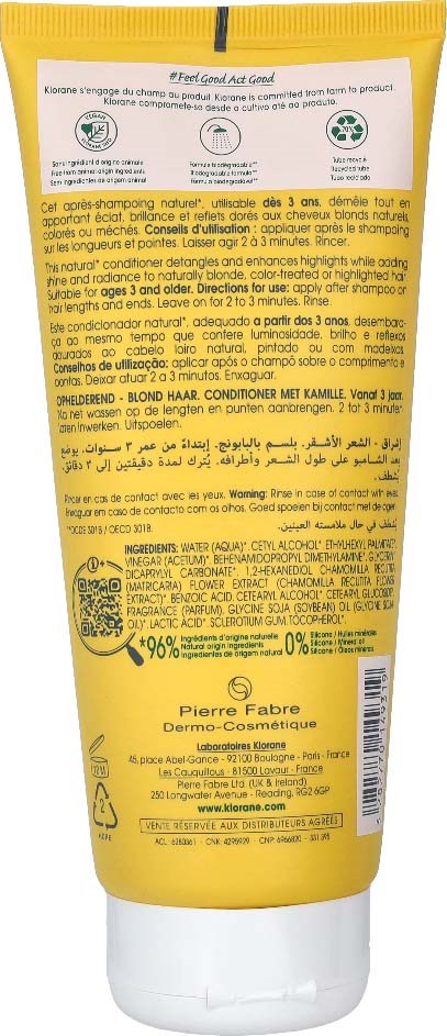 A yellow bottle with black text and a white cap, promoting hair conditioner for blond hair and containing natural ingredients.