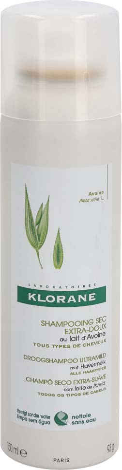 A white bottle of Klorane shampoo with green and black text, showing plant images on the label.