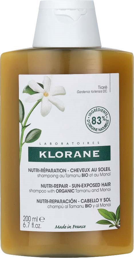 A 200ml bottle of Klorane sun-exposed hair shampoo with organic Tamanu, featuring a white flower illustration on the label.