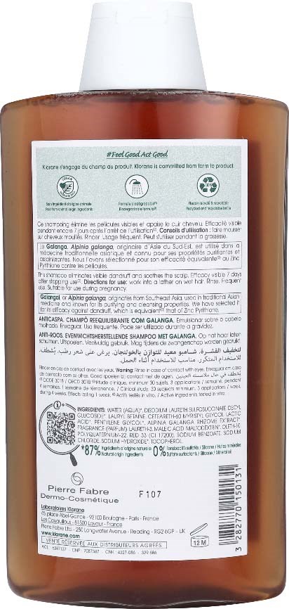 A brown shampoo bottle with a white cap and a label with text and symbols on the back.