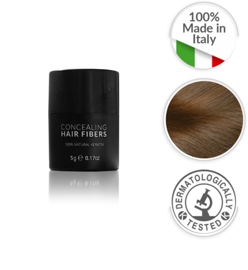 Liten svart behållare med hårfiberskoncealer, med etikett som visar naturlig keratin och testsymboler. Innehåller en logga för tillverkad i Italien.