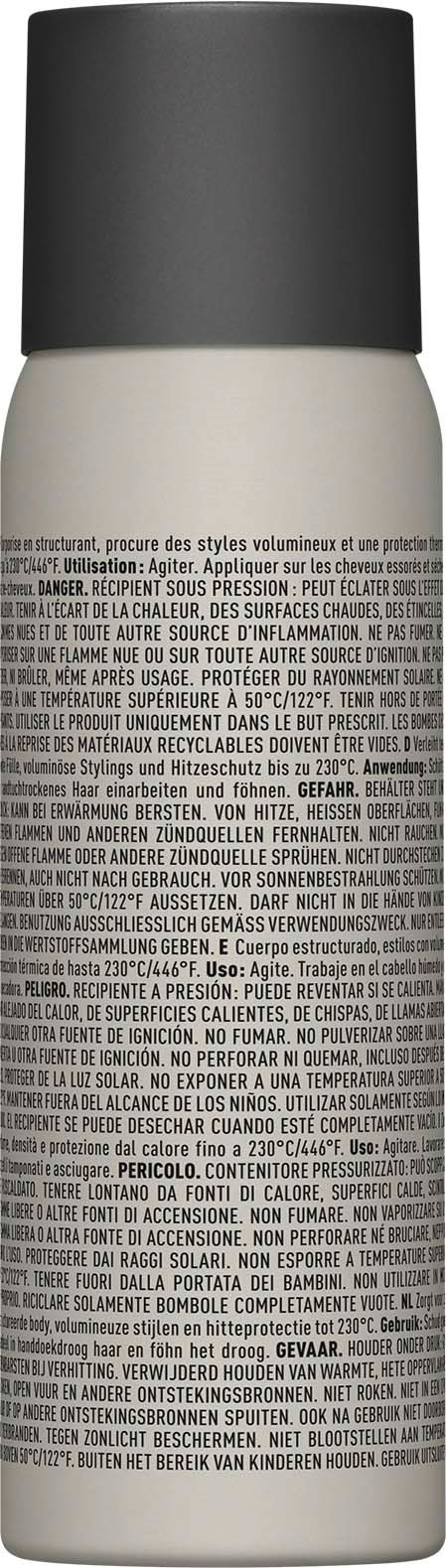 En vit sprayflaska med svart lock och mycket liten tryckt text på kroppen.