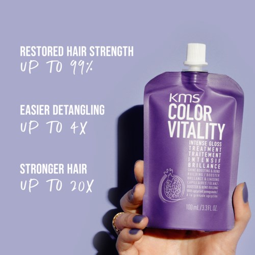 A hand holds a purple bottle of KMS Color Vitality hair treatment, with text highlighting its benefits for hair strength and detangling.