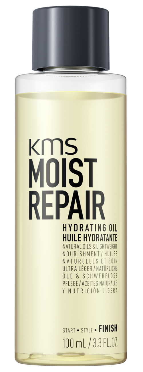 En lång klar flaska med svart lock, märkt "KMS Moist Repair" återfuktande olja, beskriver fördelar för hud eller hår.