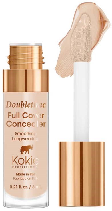 En tub med foundation med beige flytande och en borste applicator.