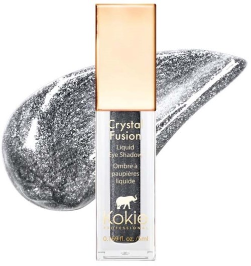 Klare flüssige Lidschatten in einer kleinen Tube mit goldener und schwarzer Beschriftung, vor einem silbernen, glitzernden Hintergrund.