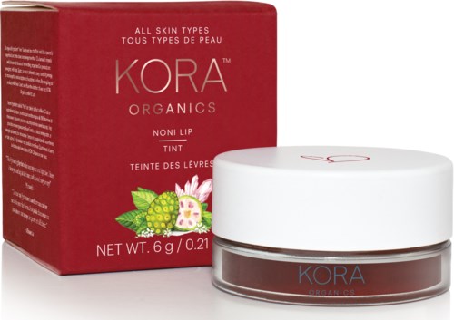 En ask och burk med KORA Organics icke-läppfärgtint med en rosa och grön fruktillustration på förpackningen.