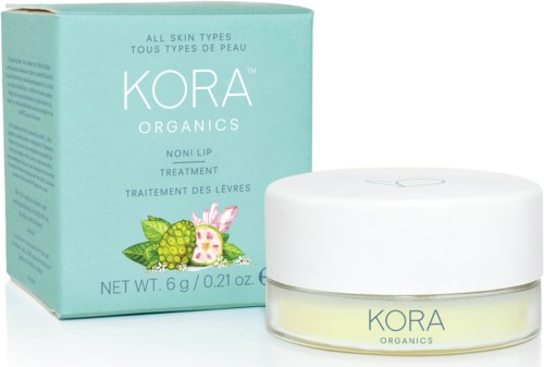En liten vit burk och blå förpackning av Kora Organics Noni Lip Treatment för alla hudtyper.