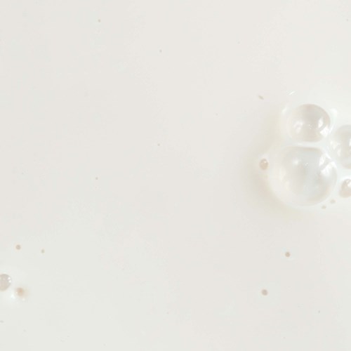Clear bubbles float on a white background with some tiny dots.