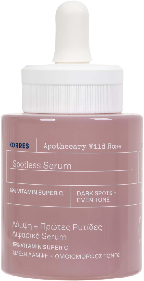 Een kleine, roze fles met een witte pipetdop, gelabeld 'Korres Apothecary Wild Rose Spotless Serum' en noemt vitamine C.