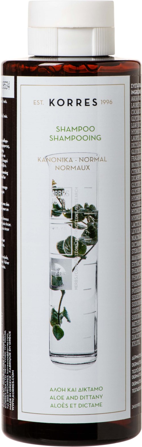 En brun flaska med vit lock, märkt Korres schampo för normalt hår med aloe och dittamö.