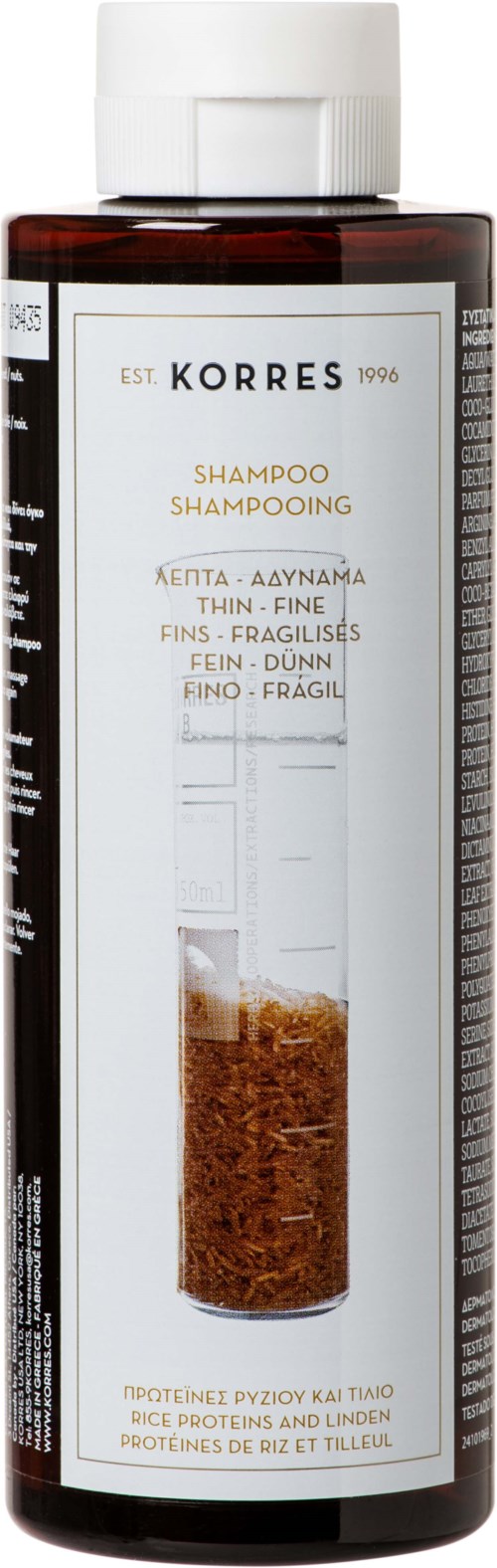 A bottle of Korres shampoo with a brownish liquid and white cap, label shows product details and brand name.